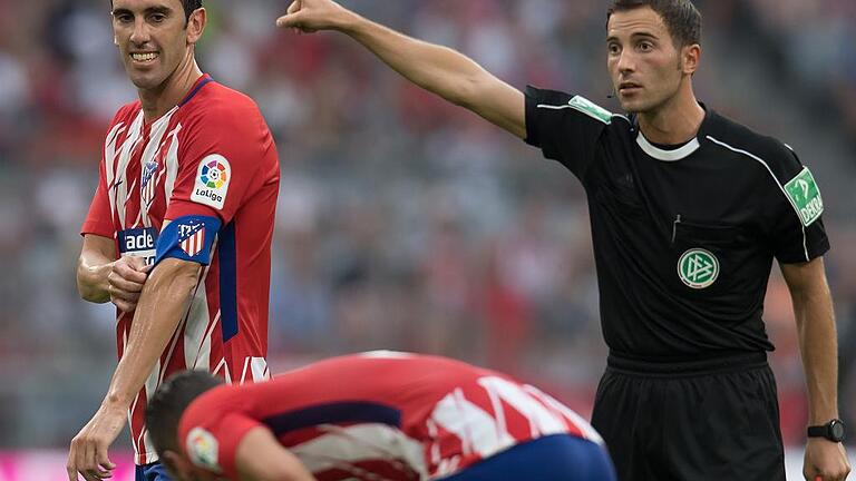 Audi Cup - Atletico Madrid - SSC Neapel       -  Auf Wiedersehen: Schiedsrichter Benjamin Brand (rechts) schickte Atletico Madrids Kapitän Diego Godin beim Turnier um den Audi-Cup mit der gelb-roten Karte vom Platz.