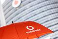 Vodafone-Deutschlandzentrale       -  Ein Passant geht mit einem aufgespanntem Regenschirm mit dem Logo von Vodafone an der Zentrale der Deutschlandtochter des britischen Vodafone-Konzerns vorbei.