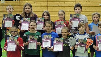 Stolz präsentieren die Sieger der jeweiligen Altersklassen der Tischtennis-Mini-Meisterschaft ihre Urkunden inmitten der Organisatoren (von links) Joe Wirth, Eva Snaschel, den Schulleitern Robert Jäger und Melanie Dotzer sowie (von rechts) Peter Suckfüll von der Volksbank-Raiffeisenbank Rhön-Grabfeld, 3. Bürgermeister Frank Vetter und dem Turnierleiter Josef van Eckert (TTC Mellrichstadt).