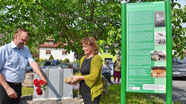 Gemeinderätin Birgit Reder-Zirkelbach und Kreisheimatpfleger Reinhold Albert legen am Gedenkstein am Radweg in Kleineibstadt Rosen und einen Stein nieder. Gemeinderätin Birgit Reder-Zirkelbach und Kreisheimatpfleger Reinhold Albert legen am Gedenkstein am Radweg in Kleineibstadt Rosen und einen Stein nieder. 