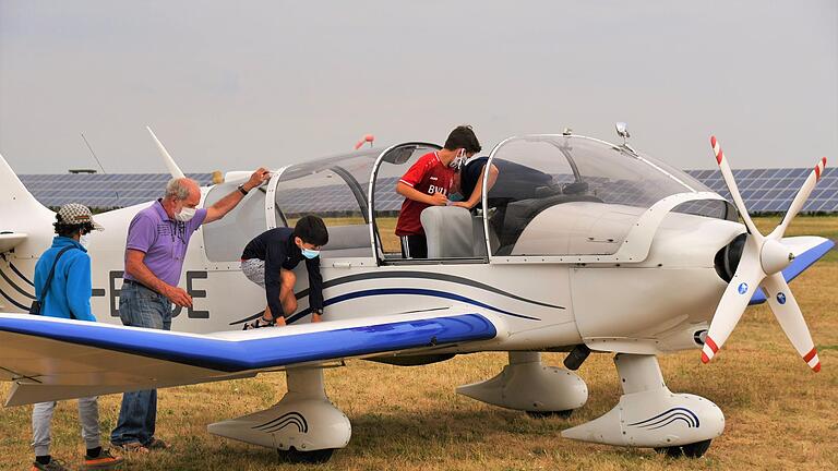 Segelflieger Gerd Walz hilft den Kindern beim Einsteigen in den Sportflieger Robin DR400.