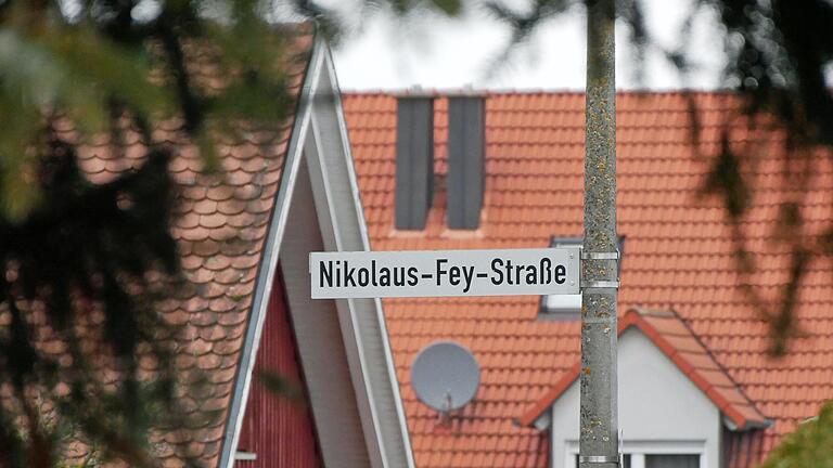 Nach dem NS-belasteten Heimatdichter Nikolaus Fey sind gut 20 Straßen in Unterfranken benannt. Einige wurden und werden umbenannt, nicht so die Nikolaus-Fey-Straße in Bergtheim im Landkreis Würzburg (Bild). Die Schilder sollen aber mit einer erklärenden Hinweistafel ergänzt werden.