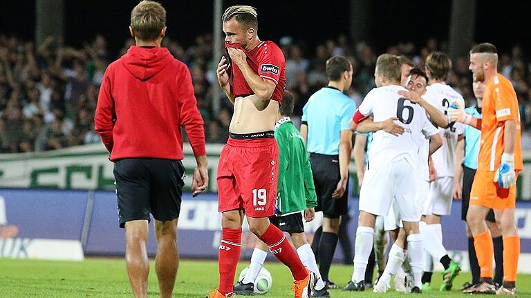 Fussball, BFV Verbandspokal, Achtelfinale, 1. FC Schweinfurt 05 - FC Würzburger Kickers       -  Verkehrte Welt: Kickers-Stürmer Orhan Ademi (Mitte) und sein Trainer Michael Schiele waren nach der Derby-Niederlage enttäuscht, die Schweinfurter bejubelten den 3:1-Erfolg. Ins Toto-Pokal-Viertelfinale ziehen nun womöglich trotzdem die Würzburger ein.