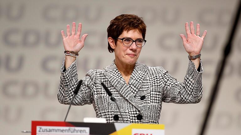 GERMANY-POLITICS-CDU-CONGRESS - Germany's conservative Christian Democratic Union (CDU) party's Secretary General Annegret Kramp-Karrenbauer reacts on stage after she was elected as party's leader during the CDU congress on December 7, 2018 at a fair hall in Hamburg, northern Germany. - German Chancellor Angela Merkel will hand off leadership of her party after nearly two decades at the helm, with the race wide open between a loyal deputy and a longtime rival. (Photo by Odd ANDERSEN / AFP) GERMANY-POLITICS-CDU-CONGRESS - Germany's conservative Christian Democratic Union (CDU) party's Secretary General Annegret Kramp-Karrenbauer reacts on stage after she was elected as party's leader during the CDU congress on December 7, 2018 at a fair hall in Hamburg, northern Germany. - German Chancellor Angela Merkel will hand off leadership of her party after nearly two decades at the helm, with the race wide open between a loyal deputy and a longtime rival. (Photo by Odd ANDERSEN / AFP)