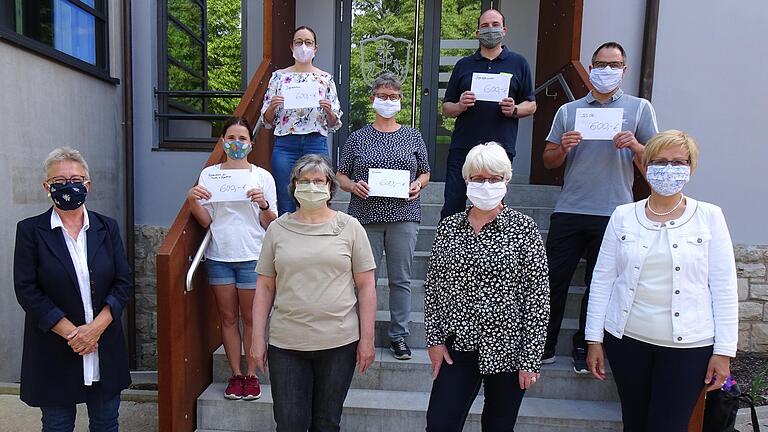 Die Nähaktion von Gesichtsmasken hilft nicht nur gegen Corona, sondern auch den örtlichen Vereinen. Die Initiatorinnen (vordere Reihe, von links) Marion Reuther, Ute Ehrenfels, Jutta Heymanns und Maria Brohm überreichten Schecks in Höhe von je 600 Euro für die Jugendarbeit in Förderverein, Jugendzentrum, Bücherei, Jugendfeuerwehr und Sportgemeinschaft.