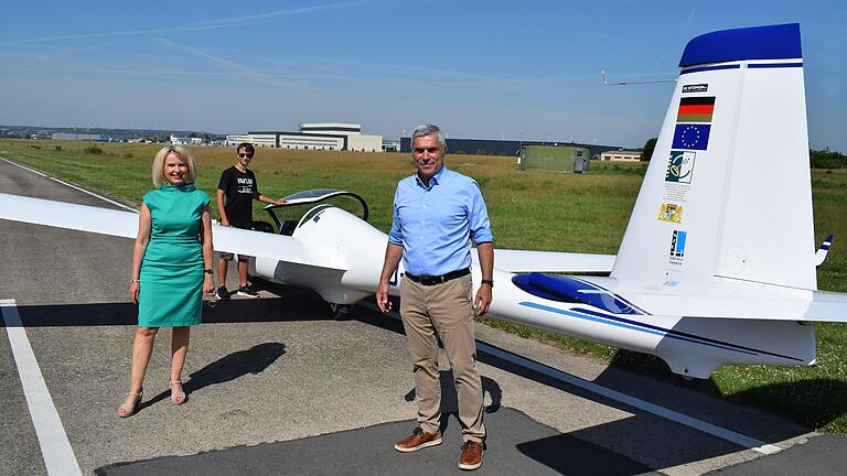 Der LSC-Vorsitzende Herbert Sattler präsentiert Landrätin Tamara Bischof das moderne Segelflugzeug, auf dem jetzt junge Piloten wie Leopold Fischer (im Hintergrund) ausgebildet werden können.