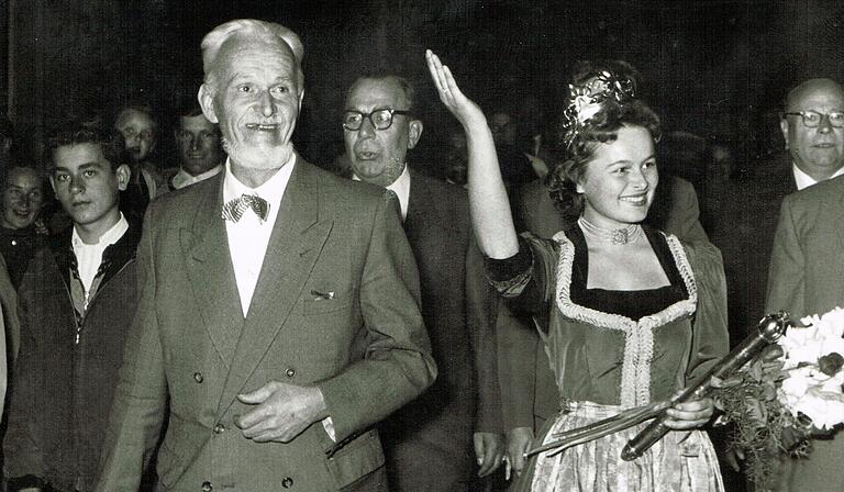 Die frisch gekrönte Deutsche Weinkönigin Karoline Hartmann nach ihrer Wahl im August 1957 mit dem fränkischen Künstler Richard Rother (links). Die frisch gekrönte Deutsche Weinkönigin Karoline Hartmann nach ihrer Wahl im August 1957 mit dem fränkischen Künstler Richard Rother (links).