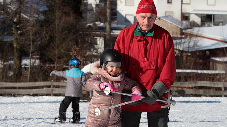 Von Beginn an aktiv dabei und immer noch mit 83 Jahren am Skihang in Neuschleichach: Der langjährige Zweite Vorsitzende Alfons Neeb gibt Urenkelin Zoe Tipps zum Skifahren.