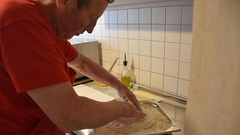 Gekonnt drückt Thomas Schumacher die Luft aus der Mitte des Pizzateiges an den Rand.