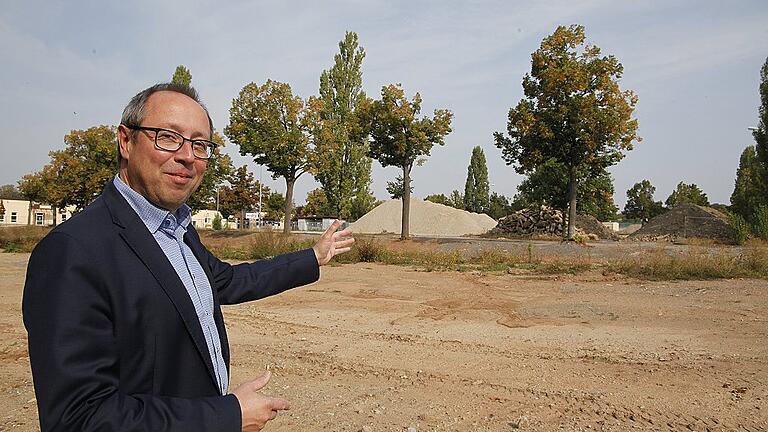 Weiß schon, wie es aussehen soll: Baureferent Ralf Brettin zeigt inmitten der Baustelle in den Ledward-Kasernen in die Richtung, wo 2026 der große Park der Landesgartenschau entstehen soll.