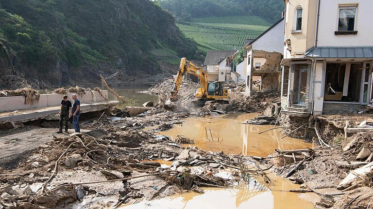 Das fünf Tage nach der Ahr-Flut aufgenommene Bild zeigt die verheerenden Zerstörungen, die das Wasser des über die Ufer getretenen Baches im Winzerort Mayschoß im Landkreis Ahrweiler angerichtet hat. Im Ortskern sind zahlreiche Häuser von der Flutwelle stark in Mitleidenschaft gezogen oder ganz fortgerissen worden. Das fünf Tage nach der Ahr-Flut aufgenommene Bild zeigt die verheerenden Zerstörungen, die das Wasser des über die Ufer getretenen Baches im Winzerort Mayschoß im Landkreis Ahrweiler angerichtet hat. Im Ortskern sind zahlreiche Häuser von der Flutwelle stark in Mitleidenschaft gezogen oder ganz fortgerissen worden.