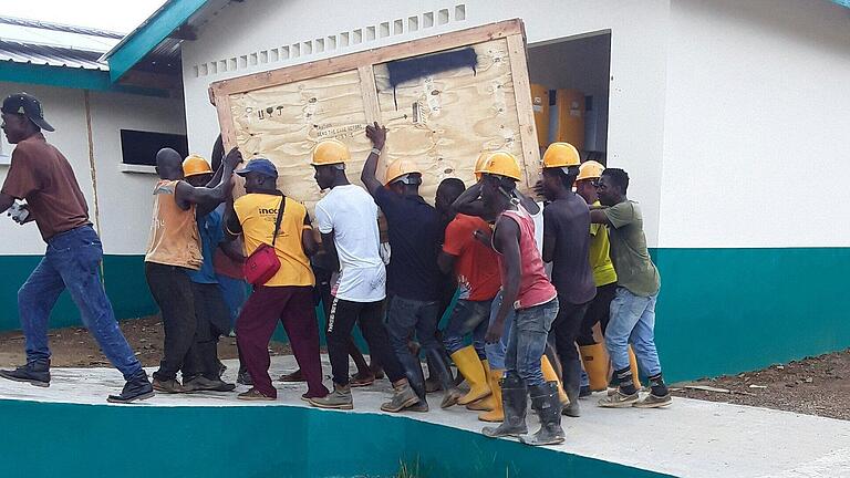 Mit vereinten Kräften: Helfer bringen ein Strahlenschutzfenster der Lohrer Firma in eine neu gebaute Krankenstation in Liberia. Rund 160 Kilo wiegt ein solches Fenster mit Bleiglas und Blei im Rahmen. Mit vereinten Kräften: Helfer bringen ein Strahlenschutzfenster der Lohrer Firma in eine neu gebaute Krankenstation in Liberia. Rund 160 Kilo wiegt ein solches Fenster mit Bleiglas und Blei im Rahmen.
