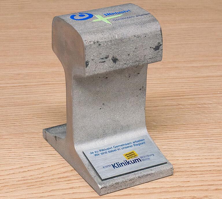 Ein (ge-)wichtiges Symbol: 3,9 Kilogramm wiegt das Gleisstück einer Würzburger Straßenbahnlinie, das die Mainfränkischen Werkstätten dem KWM überreichten. Ein (ge-)wichtiges Symbol: 3,9 Kilogramm wiegt das Gleisstück einer Würzburger Straßenbahnlinie, das die Mainfränkischen Werkstätten dem KWM überreichten.
