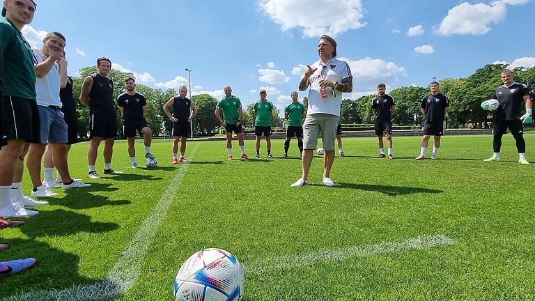 Der Chef spricht: Geschäftsführer und Hauptsponsor Markus Wolf erklärt der Mannschaft und insbesondere den Neuzugängen seine Vorstellungen. Hinten in grün das Trainerteam mit (von links) Co-Trainer Adam Jabiri, Torwarttrainer Norbert Kleider und Cheftrainer Marc Reitmaier.