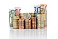 Euro       -  euro coins piled up and rolled bills, five, ten, twenty and fifty euro isolated on white background