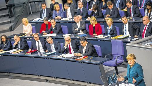 Das neue Bundeskabinett hinter sich: Kanzlerin Angela Merkel (rechts) bei ihrer Regierungserklärung am Mittwoch in Berlin.