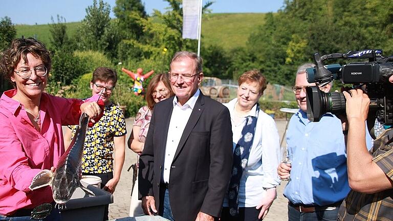 Michaela Gerstner-Scheller hält einen ausgewachsenen Zander in den Händen. Die Teichwirtin machte Bezirkstagspräsident Erwin Dotzel bei dessen Sommerreise auf die Sorgen ihrer Branche aufmerksam. Fotos: Ralf Dieter