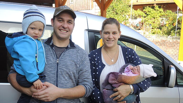 Die Eltern Florian und Maria Vogt freuen sich mit Sohn Ludwig auf ihren Nachwuchs Johanna vor ihrem Haus in Rieneck und dem Auto, das als Entbindungsstation diente.