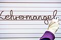 Eine Lehrerin schreibt auf ein Whiteboard in einer Grundschule das Wort Lehrermangel. Laut BLLV fehlen 4000 Lehrkräfte an Bayerns Grund-, Mittel- und Förderschulen.