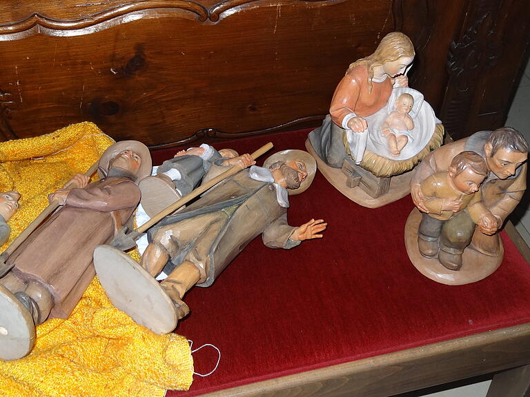 Die Figuren warten auf der Kirchenbank bis sie aufgestellt werden.