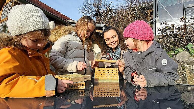 mun-eik-Julia Osterman 20221230_111726       -  Julia Osterman zeigt ihren Töchtern Penelope (links), Lima (Mitte) und Freja (rechts) eine Wildbienenbrut in einer speziellen Nisthilfe.