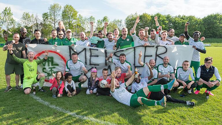 Das Meisterteam des VfL Sportfreunde Bad Neustadt: Benedikt Kolb (vorne von links), Michael Gerhardt, Jakob Rat, Ridwan Mahamud Hussein, Daniel Gleißner, Timo Sitzmann, Paul Fiedler, Marc Kürschner und Nico Schmidt (liegend) sowie (hinten von links) drei Fans, dann Stefan Fleischer, Robert Hüllmantel, Billy Kucejko, Frederick Püschel, Trainer Peter Lächner, Julian Dorsch, Michael Wieczorek, Marco Kastl, Walter Della Coletta (verdeckt), Christian Dietz, Tobias Werner, Nico Schmitt, Mohammad Khavari, Florian Übler und Faysal Adji Beda.