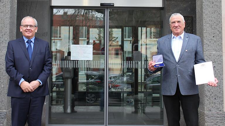 Regierungspräsident Dr. Eugen Ehrmann (links) überreicht die Kommunale Verdienstmedaille in Bronze und die dazugehörige Urkunde an Alfred Frank&nbsp; aus Gräfendorf.