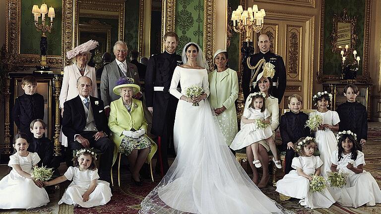 Offizielle Hochzeitsbilder von Prinz Harry und Meghan       -  Auf diesem vom Kensington-Palast zur Verfügung gestellten offiziellen Hochzeitsbild von Prinz Harry und Herzogin Meghan (Mitte) sind neben Blumenmädchen und Pagen abgebildet Herzogin Camilla und Thronfolger Prinz Charles (hinten links), davor Prinz Philip und Königin Elizabeth II. Rechts neben Herzogin Meghan ihre Mutter Doria Ragland, Prinz William, davor Herzogin Kate, Prinzessin Charlotte und Prinz George.