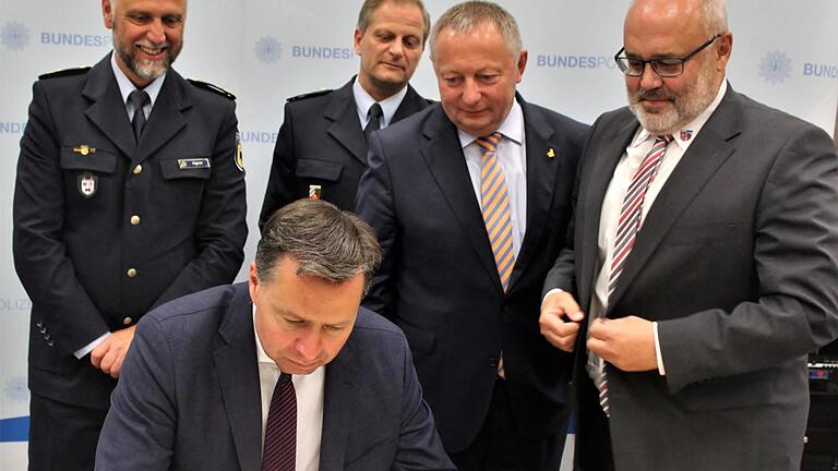 Staatssekretär Stephan Mayer trägt sich ins goldene Buch der Gemeinde Oerlenbach ein, dahinter (von links) Polizeipräsident Alfons Aigner, Polizeidirektor Ralf Wiegand, Landrat Thomas Bold und Bürgermeister Franz Kuhn. Foto: Werner Vogel       -  Staatssekretär Stephan Mayer trägt sich ins goldene Buch der Gemeinde Oerlenbach ein, dahinter (von links) Polizeipräsident Alfons Aigner, Polizeidirektor Ralf Wiegand, Landrat Thomas Bold und Bürgermeister Franz Kuhn. Foto: Werner Vogel