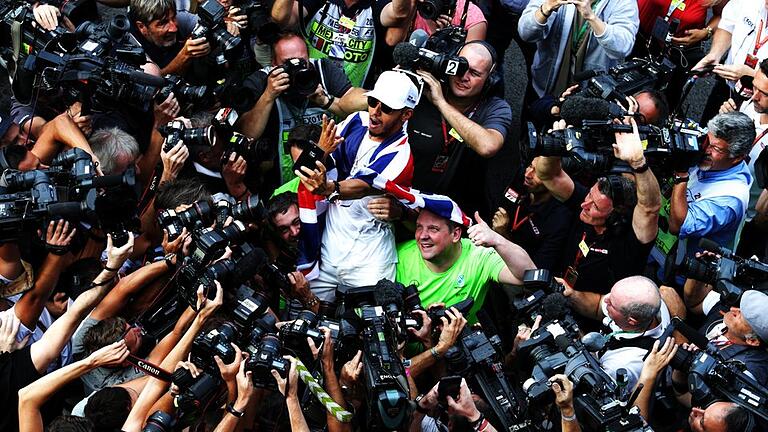 Champion       -  Der neue Formel-1-Weltmeister Lewis Hamilton (M.) ließ sich in der Reportertraube beim Selfie feiern.