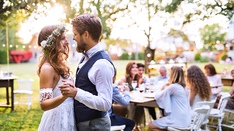 Bride and groom dancing at wedding reception outside in the backyard.       -  Die Suche nach der perfekten Hochzeitslocation ist für viele Paare eine Zerreißprobe. Warum also nicht einfach die Hochzeitsfeier zuhause ausrichten? Wir geben Tipps.