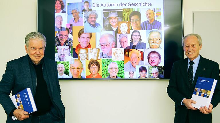 Die Herausgeber Dr. Wolfgang Drave und Dr. Hans Neugebauer vor einem Bildschirm mit den Fotos ihrer Mit-Autoren.