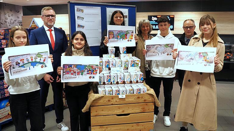 Die neue Fair-Trade-Schokolade ist da. Bei der Präsentation dabei (von links): Johanna Wieczorek (Klasse 7a Wilhelm-Sattler-Realschule), Thomas Engert (Sparkasse Schweinfurt-Haßberge), Suriayz Shamdien (Klasse R6a Walther-Rathenau-Schulen), Thalia Schurlik (9aF Wilhelm-Sattler-Realschule), Angela Merz (AG Nachhaltigkeit), Noel Mainz (Klasse 7c Montessorischulen), Roland Weber (Frischemarkt Edeka) und Antonia Schäflein (Klasse Q11 Olympia-Morata-Gymnasium) Die neue Fair-Trade-Schokolade ist da. Bei der Präsentation dabei (von links): Johanna Wieczorek (Klasse 7a Wilhelm-Sattler-Realschule), Thomas Engert (Sparkasse Schweinfurt-Haßberge), Suriayz Shamdien (Klasse R6a Walther-Rathenau-Schulen), Thalia Schurlik (9aF Wilhelm-Sattler-Realschule), Angela Merz (AG Nachhaltigkeit), Noel Mainz (Klasse 7c Montessorischulen), Roland Weber (Frischemarkt Edeka) und Antonia Schäflein (Klasse Q11 Olympia-Morata-Gymnasium)