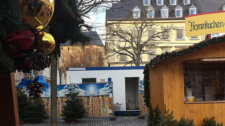 Erstmals steht am Weihnachtsmarkt ein mobiler Toilettencontainer (weiß, Bildmitte) – aber ohne Behindertentoilette. Dagegen beschwerten sich bereits Rollstuhlfahrerinnen. Der Behindertenbeirat der Stadt bat um „eine schnellstmögliche Nachbesserung“ – bisher vergebens. Erstmals steht am Weihnachtsmarkt ein mobiler Toilettencontainer (weiß, Bildmitte) – aber ohne Behindertentoilette. Dagegen beschwerten sich bereits Rollstuhlfahrerinnen. Der Behindertenbeirat der Stadt bat um „eine schnellstmögliche Nachbesserung“ – bisher vergebens.
