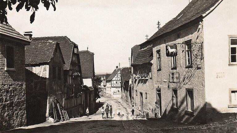 Das Obere Tor in Steinfeld mit der ehemaligen gemeindeeigenen Dorfschenke (Foto um 1930 von Franz Schaub). Im Verzeichnis des Klosters Neustadt von 1606 wird diese Stelle „vorm obern Thor beym Wirtshaus“ genannt. Das Gasthaus hieß später „Zum Ross“. Das Obere Tor in Steinfeld mit der ehemaligen gemeindeeigenen Dorfschenke (Foto um 1930 von Franz Schaub). Im Verzeichnis des Klosters Neustadt von 1606 wird diese Stelle „vorm obern Thor beym Wirtshaus“ genannt. Das Gasthaus hieß später „Zum Ross“.