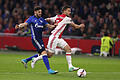 Zweikampf       -  Der Schalker Daniel Caligiuri (l) und Joel Veltman (r) von Ajax Amsterdam kämpfen um den Ball. Foto: Ina Fassbender