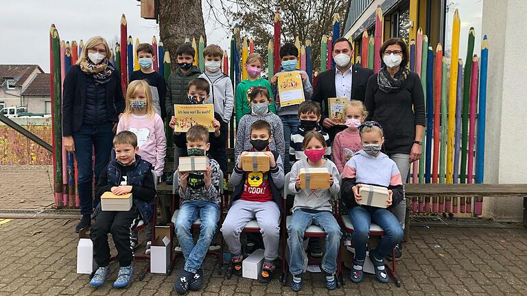 Freude über die neuen Brotzeitboxen: Die Schülerinnen und Schüler der Klasse 1a mit Bürgermeister Matthias Bielek, Rektorin Gabriele Kriegelstein (links) und der Klassenlehrerin Gabi Lenhart (rechts)