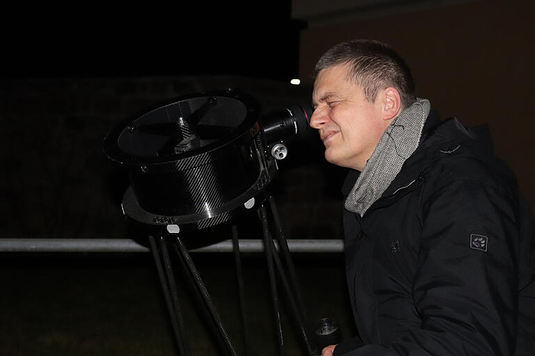 Pater Christoph schaut durch das Teleskop nach Sternen im Weltall.