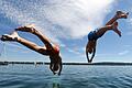 Zwei junge Männer springen am Starnberger See ins Wasser       -  Warnung vor Badeunfällen: Kopfsprünge in flaches oder trübes Wasser können zu schweren Verletzungen führen, daher Wassertiefe und Hindernisse prüfen.
