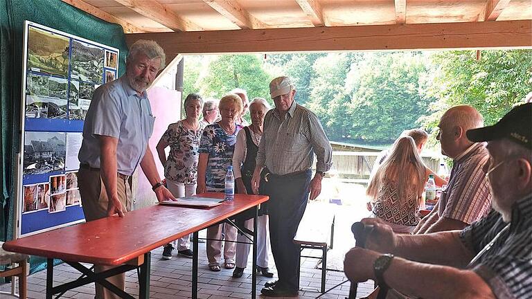Viel Beachtung fand der fundierte Vortrag von Gerhard Karg (links), der über die bloße Chronik von Heckmühle hinausging und die Historie der Region beleuchtete. Fotos: Gerd Schaar       -  Viel Beachtung fand der fundierte Vortrag von Gerhard Karg (links), der über die bloße Chronik von Heckmühle hinausging und die Historie der Region beleuchtete. Fotos: Gerd Schaar