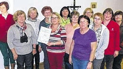 Oben: Leckere Gurken: Andrea Hein (rechts) und Britta Lutz vom Kinderhaus Rügheim testen Gurken, eingemacht nach dem Rezept im Rügheimer Koch- und Backbuch.Rechts:Zur 1200-Jahr-Feier konnten die Frauen vom Frauentreff das Kochbuch präsentieren.