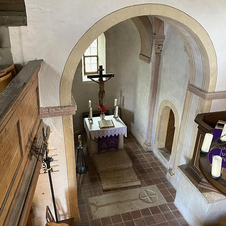 Blick von der Empore im Achteckraum der Ulrichskapelle im Creglinger Ortsteil Standorf auf die geheimnisvolle Steinplatte vor dem Altar.