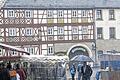 Regenmantel gefällig?       -  (bw)   Den Titel &bdquo;Regenmantelsonntag&ldquo; hätte der &bdquo;Mantelsonntag&ldquo; in Hofheim zeitweilig besser getroffen: Das Herbstwetter zeigte sich mit Regenschauern und stürmischen Böen von seiner unbequemen und nicht verkaufsfördernden Seite. Wer vor dem starken Regenschauer bereits durch die Hofheimer Innenstadt bummelte und nicht gut beschirmt war, suchte Schutz unter den Dachüberständen und in den Geschäften, um in aller Ruhe nach Schnäppchen Ausschau zu halten. Die Marktbeschicker entlang den Straßen und auf dem Marktplatz waren gut gerüstet, deckten ihre Waren mit Planen ab. Und Obstverkäufer Reinhold Dotzel aus Lindach hielt bei den starken Windböen den schützenden Schirm fest.