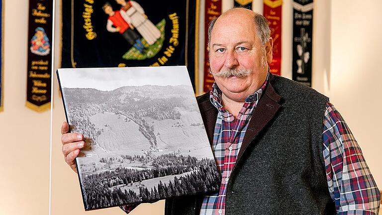 Winter in Balderschwang - Bürgermeister Konrad Kienle mit einem Foto aus den 50er Jahren, auf dem der Hang zu sehen ist, von dem jetzt die Lawine abgerutscht ist. Winter in Balderschwang - Bürgermeister Konrad Kienle mit einem Foto aus den 50er Jahren, auf dem der Hang zu sehen ist, von dem jetzt die Lawine abgerutscht ist.