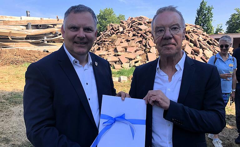 In diesem Kuvert, das Volkachs Bürgermeister Heiko Bäuerlein (links) von Claus Kiesel von der Regierung von Unterfranken erhielt, steckte der Förderbescheid über vorerst 3,6 Millionen Euro. In diesem Kuvert, das Volkachs Bürgermeister Heiko Bäuerlein (links) von Claus Kiesel von der Regierung von Unterfranken erhielt, steckte der Förderbescheid über vorerst 3,6 Millionen Euro.