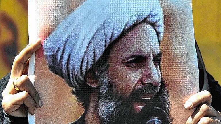 Shiite Houthis protest Saudi death sentence for Shiite leader - Eine Frau hält ein Bild des Predigers Nimr al-Nimr. Shiite Houthis protest Saudi death sentence for Shiite leader - Eine Frau hält ein Bild des Predigers Nimr al-Nimr.