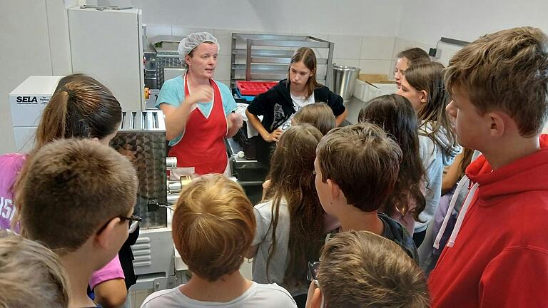 Andrea Mandel zeigt der Klasse 6a wie die Nudelmaschine funktioniert.