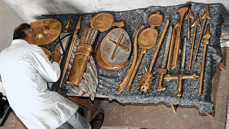 Ein Restaurator arbeitet an der Ausrüstung, die von der Figur des Kirchenpartons Mauritius am Hochaltar der katholischen Kirche in Wiesentheid abgenommen wurde.