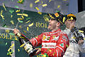 Formel 1 - Großer Preis von Australien       -  Motorsport: Formel-1-Weltmeisterschaft, Grand Prix von Australien, am 26.03.2017 in Melbourne (Australien). Der Deutsche Sebastian Vettel vom Team Scuderia Ferrari jubelt nach seinem Sieg auf dem Podium. Rechts steht der drittplatzierte Finne Valtteri Bottas vom Team Mercedes AMG Petronas F1. Foto: Andy Brownbill/AP/dpa +++(c) dpa - Bildfunk+++ |