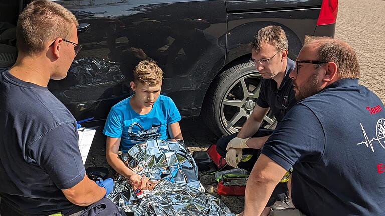 Kreislaufschwäche durch Unterzuckerung: Ausbilder Ariel Karwacki (rechts) befragt die Ersthelfer nach deren Versorgung eines Autofahrers. - Kreislaufschwäche durch Unterzuckerung: Ausbilder Ariel Karwacki (rechts) befragt die Ersthelfer nach deren Versorgung eines Autofahrers. Kreislaufschwäche durch Unterzuckerung: Ausbilder Ariel Karwacki (rechts) befragt die Ersthelfer nach deren Versorgung eines Autofahrers. - Kreislaufschwäche durch Unterzuckerung: Ausbilder Ariel Karwacki (rechts) befragt die Ersthelfer nach deren Versorgung eines Autofahrers.